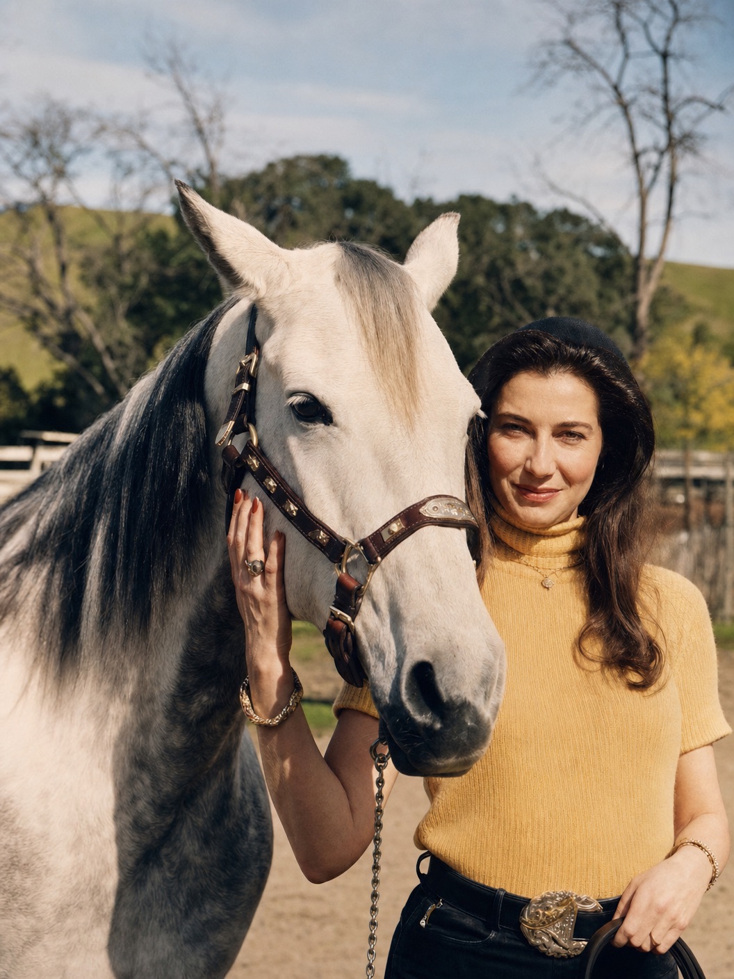 Carol Ellen, owner of Kisses Included, standing with a grey horse