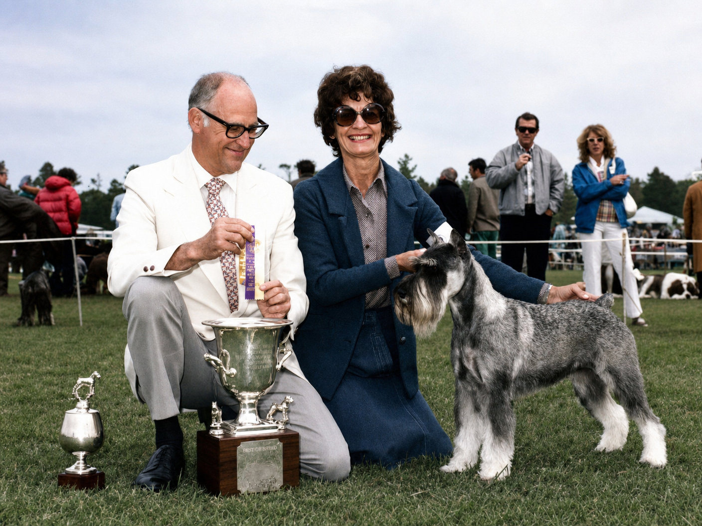 Carol's mother with a judge receiving Best of Breed trophy and ribbon with their Standard Schnauzer